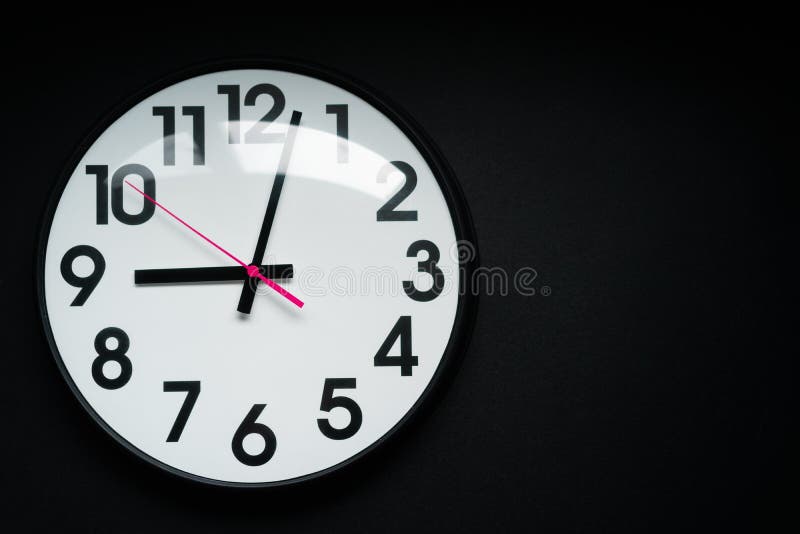 Realistic Classic Dark and White Round Wall Clock, Isolated on Black Background. Stock Image