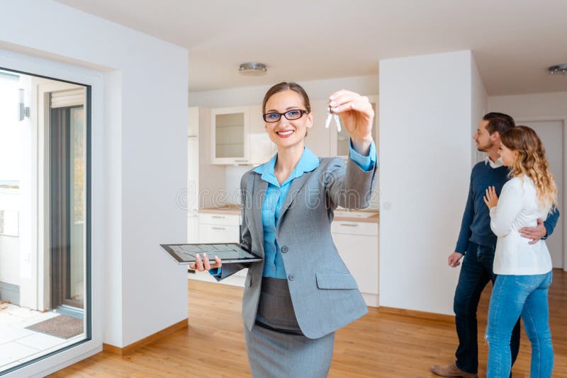 Realtor showing keys to new apartment