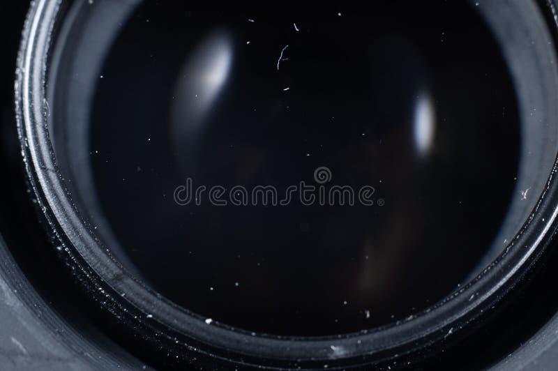 Rear Objective Lens in Dust Closeup. Round Glass with Darkness Outside