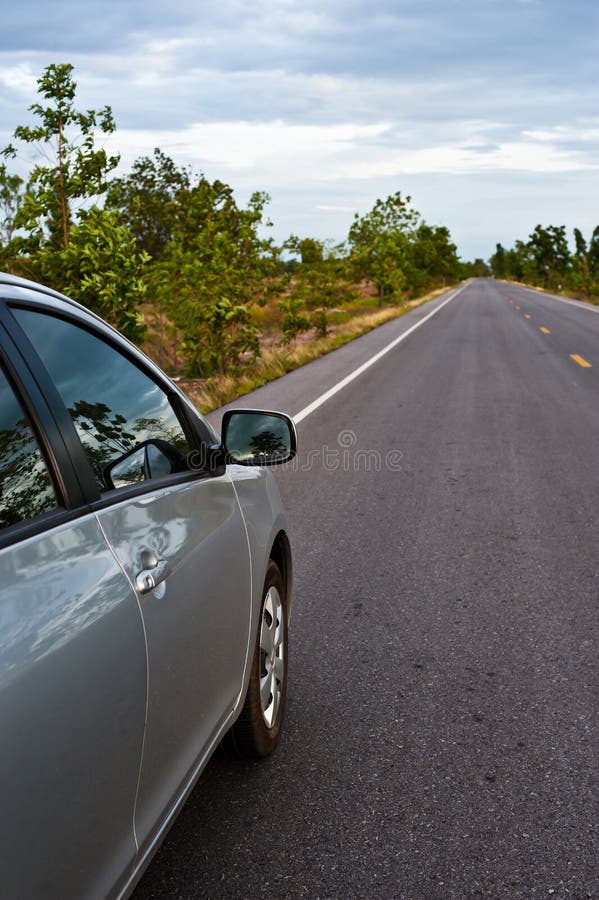 Rear Side Perspective View of Car on Road Countryside Stock Photo