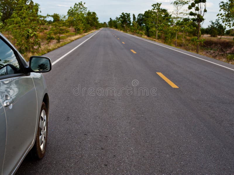 Rear Side Perspective View of Car on Road Countryside Stock Photo