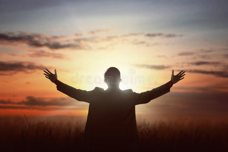 Portrait Of Man Raising Hand While Praying To God With Bright Cr Stock ...