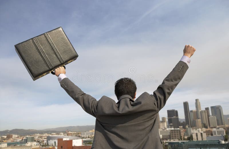 Rear View Of Businessman With Arms Out In Front Of Buildings royalty free stock photography Rear View Of Businessman With Arms Out In Front Of Buildings royalty free stock photography