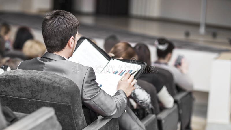 Successful businessman with financial documents sitting in a conference room for business presentations stock image Successful businessman with financial documents sitting in a conference room for business presentations stock image