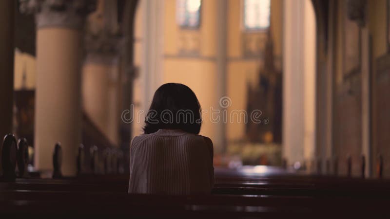 Rear view of Christian woman praying to GOD
