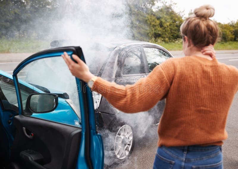 Rear View Of Female Motorist With Head Injury Getting Out Of Car After Crash stock photography Rear View Of Female Motorist With Head Injury Getting Out Of Car After Crash stock photography