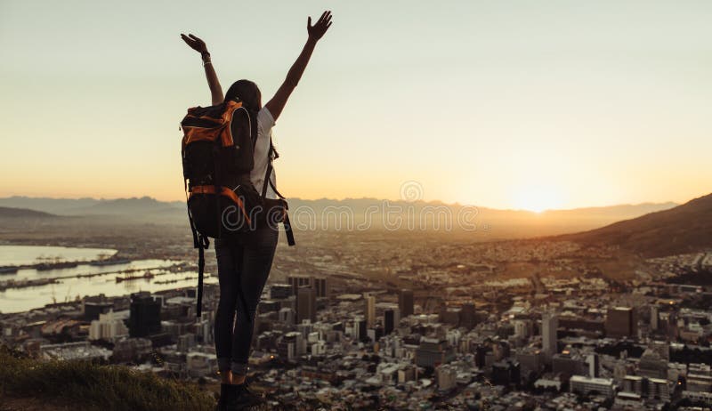 Solo traveler enjoying the city view from hill top