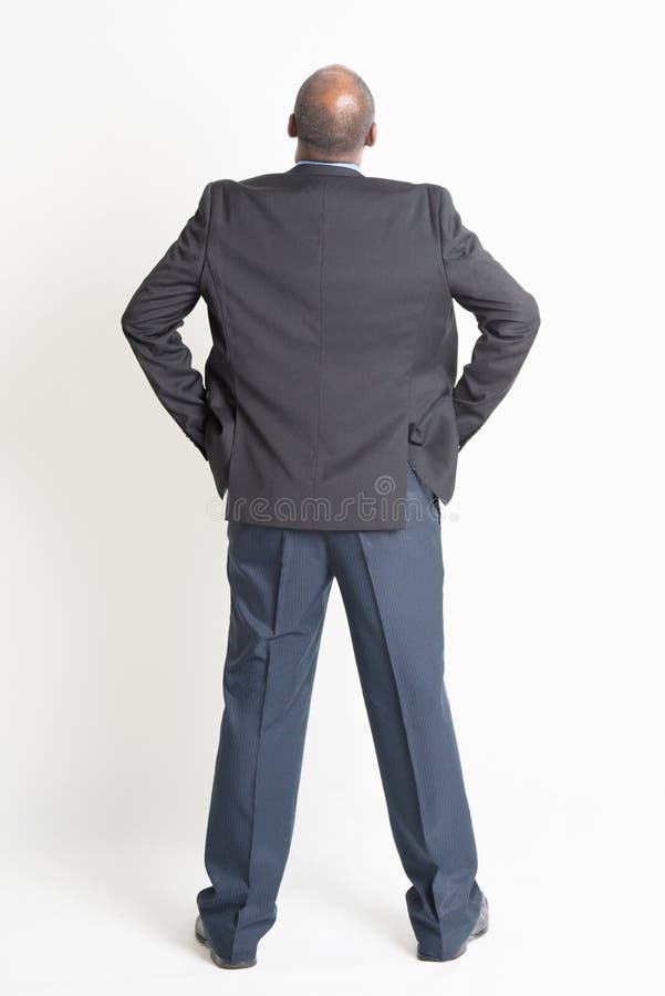 Rear view full length mature Indian businessman looking up stock photo Rear view full length mature Indian businessman looking up stock photo
