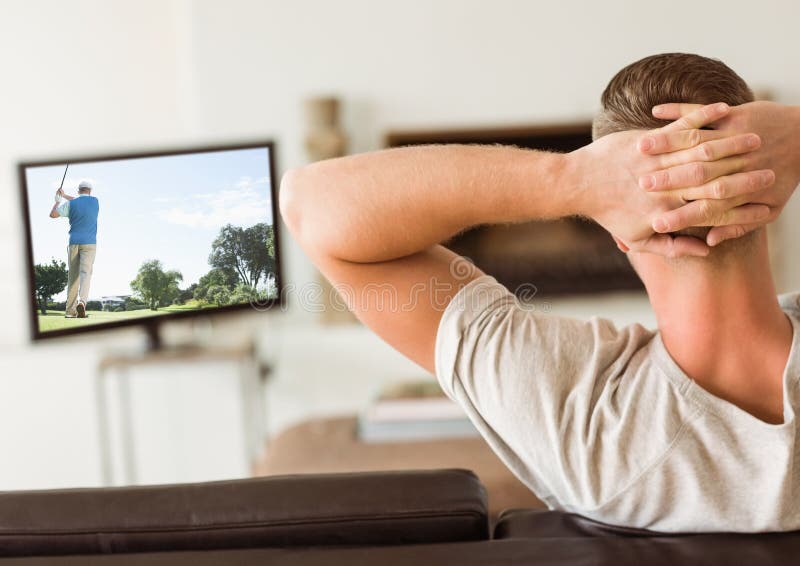 Rear view of man watching television in living room royalty free stock images Rear view of man watching television in living room royalty free stock images