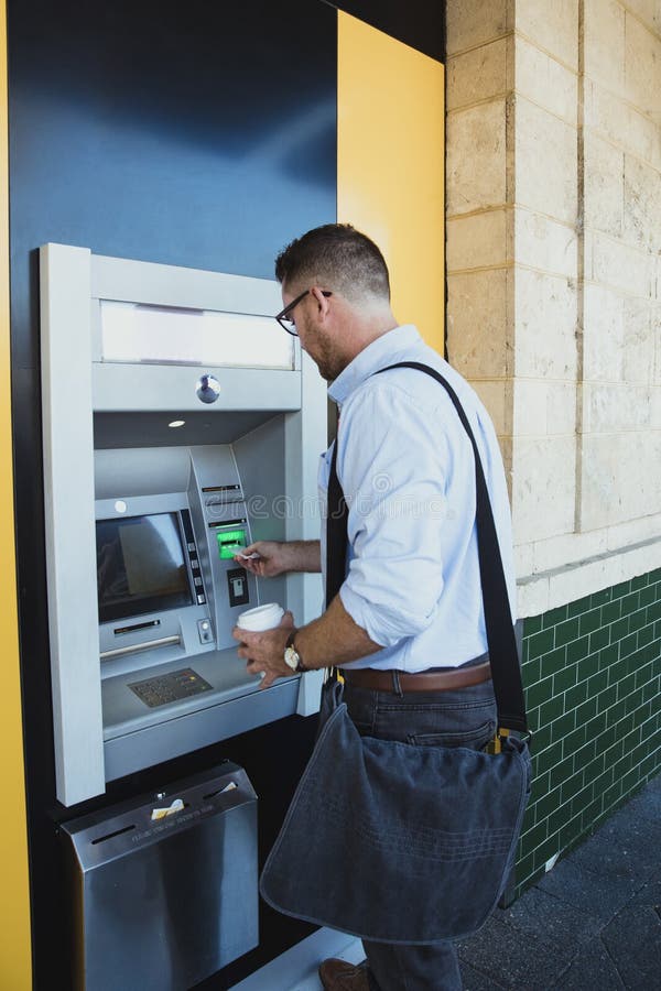 Businessman Using ATM Machine stock photos Businessman Using ATM Machine stock photos