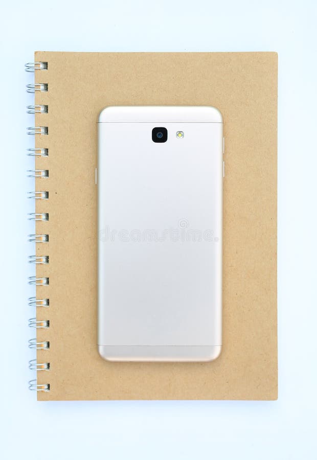 Rear view smartphone on recycle brown notebook against white background stock images