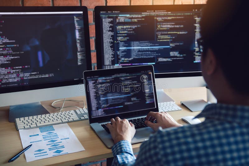 Rear view of software developers is sitting serious analyzing data on the computer screen stock images