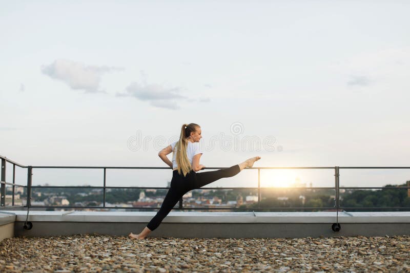 Woman doing yoga frontal split stretch Stock Photo by Photology75