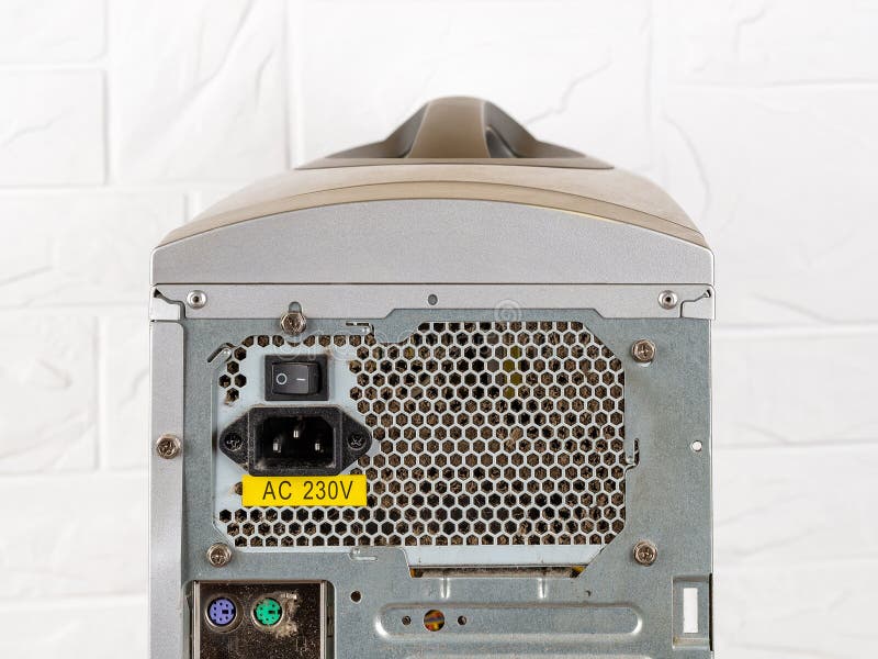 Rear view of tower computer case with dusty faulty power supply unit before replacement with a new one. Personal computer PSU royalty free stock photography