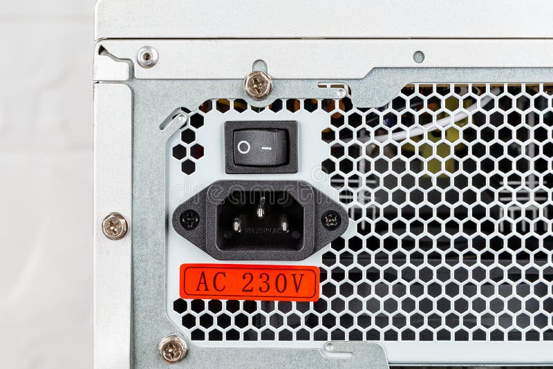 Rear view of tower computer case with new power supply unit installed. On Off switch, power cord socket and voltage sticker on royalty free stock photos