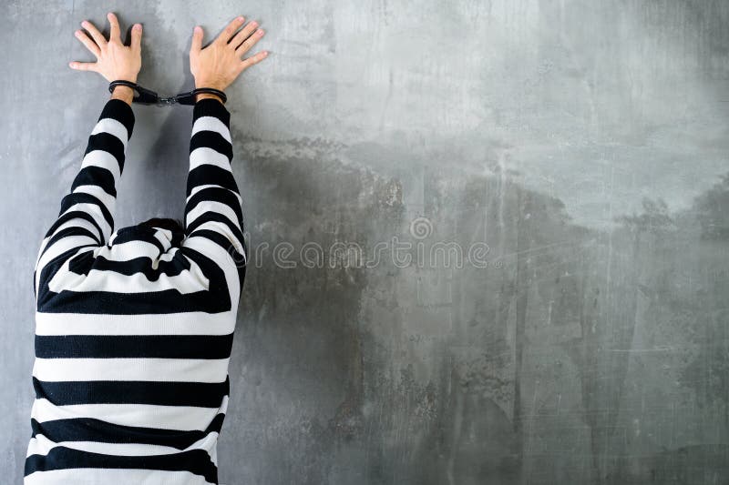 Rear view of unidentified prisoner in prison stripped uniform st stock photo Rear view of unidentified prisoner in prison stripped uniform st stock photo