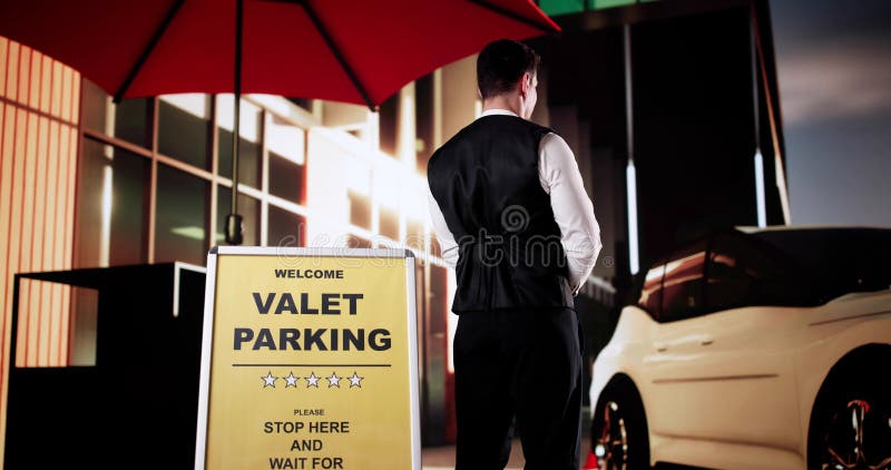 Rear View Of A Valet Standing In Front Of White Car