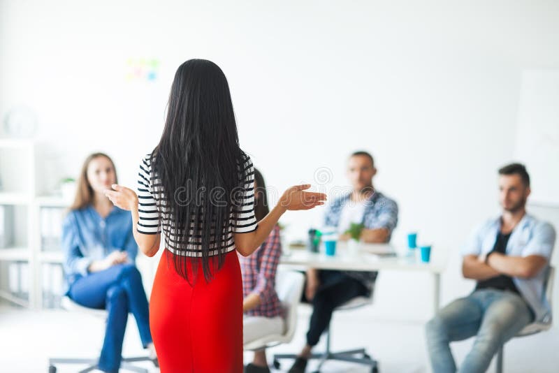 Rear view of woman business coach gesturing with hand royalty free stock image Rear view of woman business coach gesturing with hand royalty free stock image