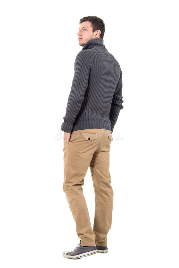 Rear view of young casual man in gray sweater looking up over shoulder