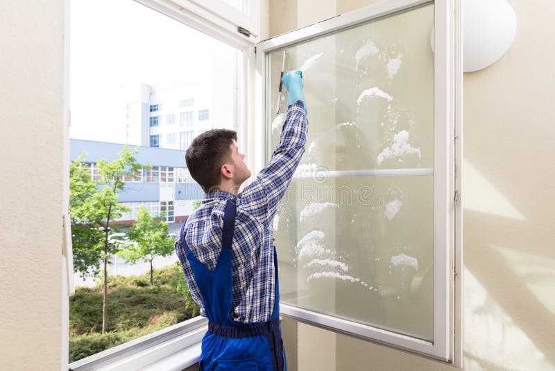 Housekeeper Cleaning Window