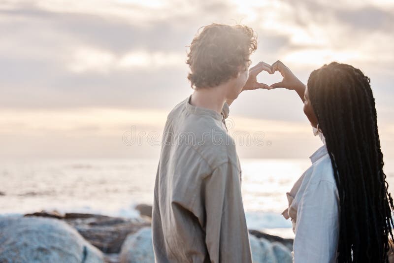Youve Taught Me The True Meaning Of Love. A Couple Forming A Heart Shape  With Their Hands While Sitting On The Beach. Stock Photo, Picture and  Royalty Free Image. Image 198911221.