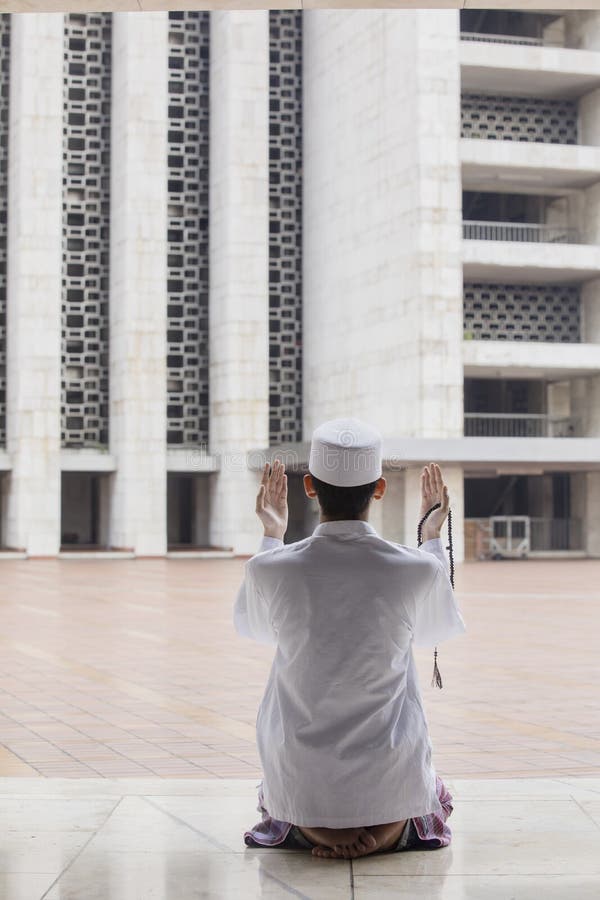 Young Muslim man praying to the Allah royalty free stock photo Young Muslim man praying to the Allah royalty free stock photo