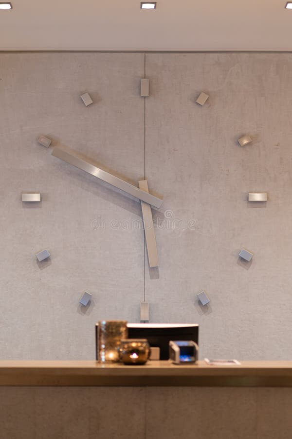Reception Desk in Hotel with Giant Watch at the Background Stock Photo -  Image of modern, background: 176051472