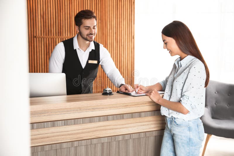 Receptionist Registering Client at Desk Stock Image Image of