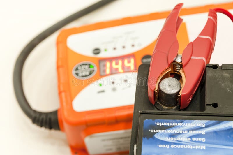Recharging the Car Battery. Red Copper Clip Attached To the Plus