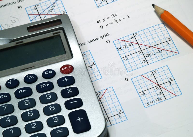 A calculator with pencil on math textbook. A calculator with pencil on math textbook.