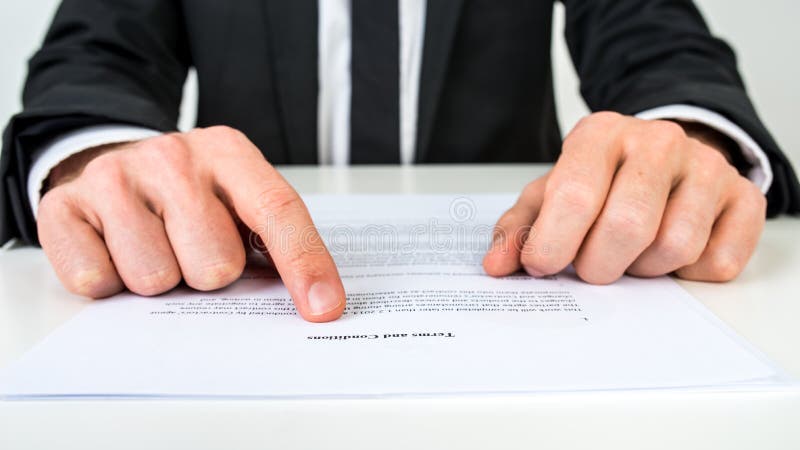 Closeup of a lawyer or a real estate agent proofreading Terms and conditions document. Closeup of a lawyer or a real estate agent proofreading Terms and conditions document.