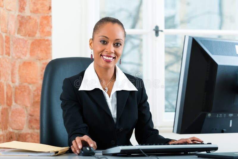 Young female lawyer or paralegal working in her office on a Computer or Pc. Young female lawyer or paralegal working in her office on a Computer or Pc