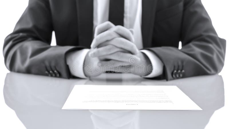 Detail of lawyer sitting at white desk with his hands together. Giving advice concept. Detail of lawyer sitting at white desk with his hands together. Giving advice concept.