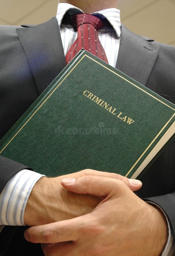 Lawyer holding criminal law book , law concept , justice concept. Lawyer holding criminal law book , law concept , justice concept