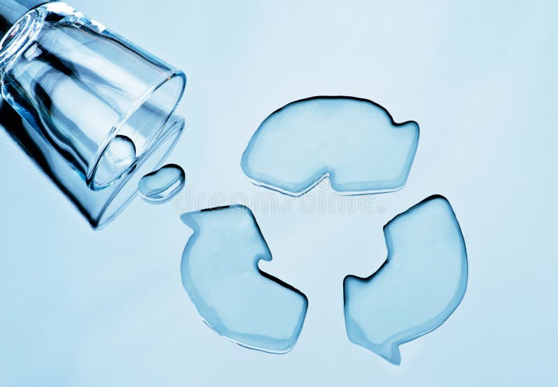 Water recycling. Glass of water spilled into shape of recycle symbol. Water recycling. Glass of water spilled into shape of recycle symbol