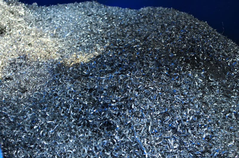 Steel scrap materials recycling. Abstract, background and texture of metal shavings. Aluminum chip waste after machining metal parts on a cnc lathe. Steel scrap materials recycling. Abstract, background and texture of metal shavings. Aluminum chip waste after machining metal parts on a cnc lathe