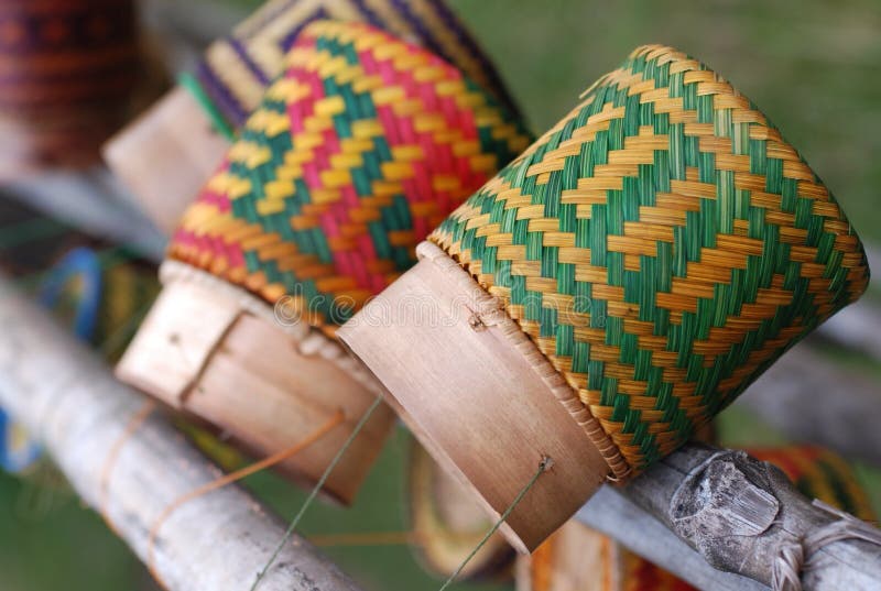 Colourful wicker containers, used to serve sticky rice in Asia. Here they are hung up to air out on a fence. Colourful wicker containers, used to serve sticky rice in Asia. Here they are hung up to air out on a fence.