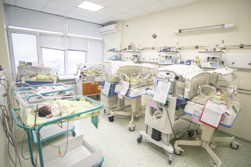 A nursery in a birth hospital with newborns and incubators. A nursery in a birth hospital with newborns and incubators