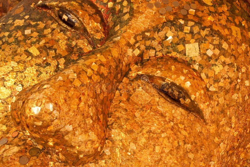 Reclining Buddha image covered with gold leaves