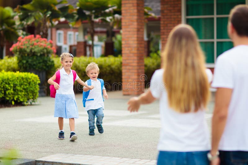 Recogida escolar. madre e hijos después de la escuela foto de archivo