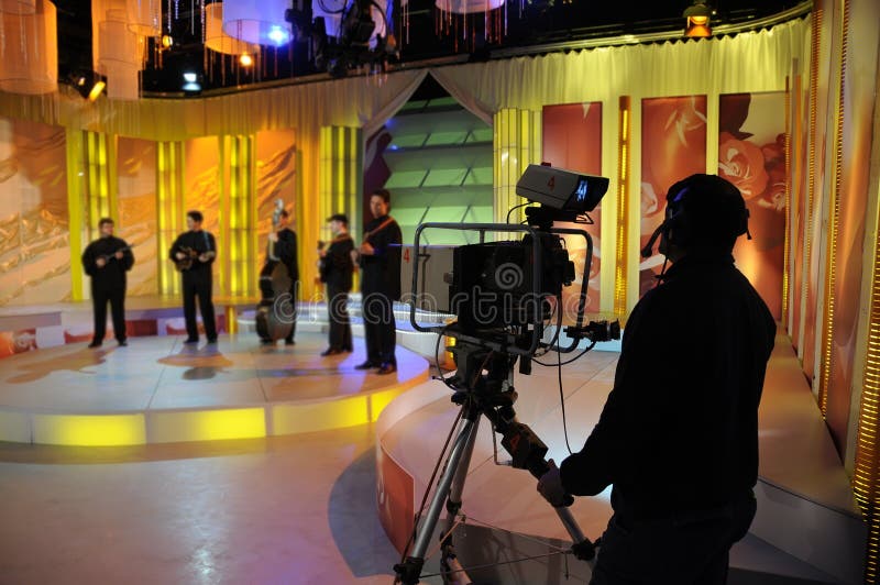 Cameraman works in the studio - recording show in TV studio. Cameraman works in the studio - recording show in TV studio