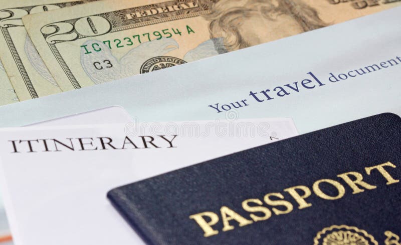 A spread of international travel necessities including a passport, itinerary, money and other travel documents. A spread of international travel necessities including a passport, itinerary, money and other travel documents.