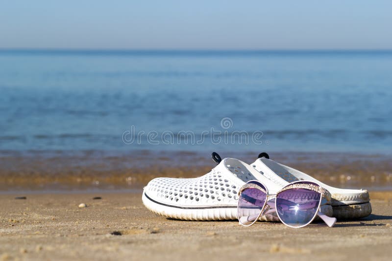 Summer Vacation on the Sea. Female Feet in Sandals Laying on Golden ...