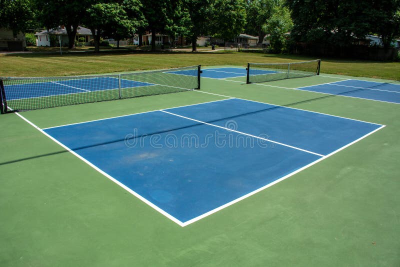 Recreational sport of pickleball court in Michigan, USA looking at an empty blue and green new court at a outdoor park