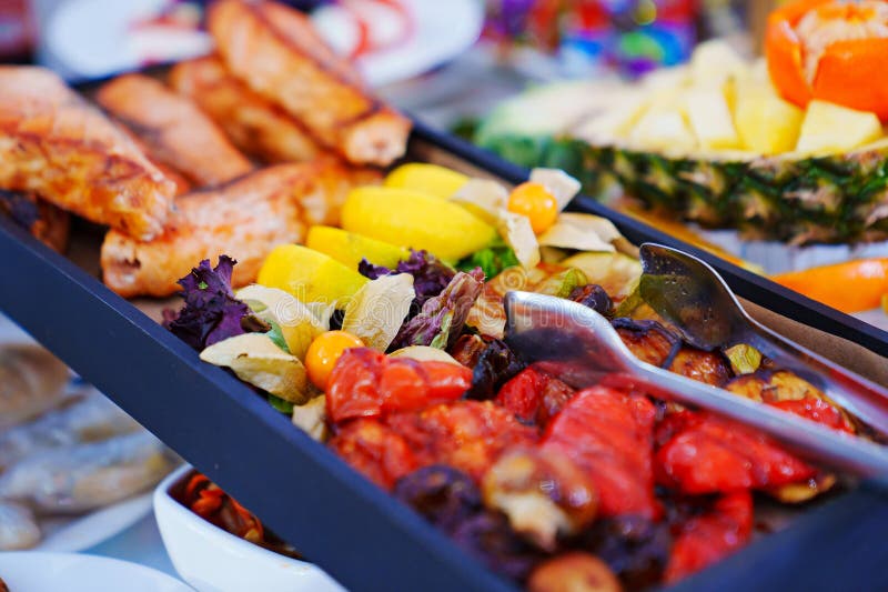 Rectangular Black Dish with Grilled Fish and Vegetables. Stock Photo