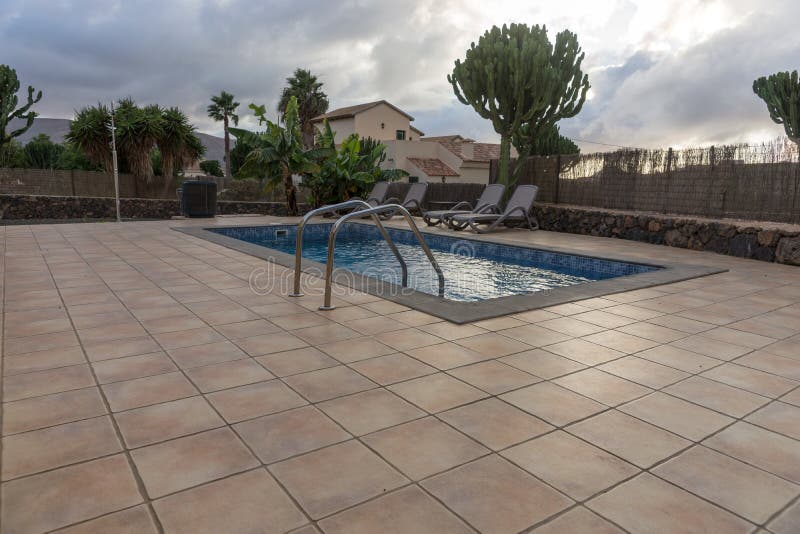 Rectangular swimming pool with paved surrounds