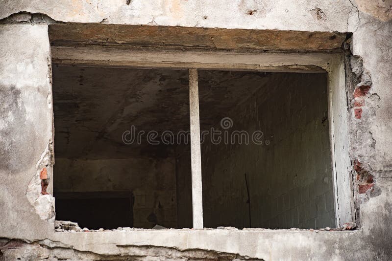 Rectangular window without glasses of an abandoned building stock images