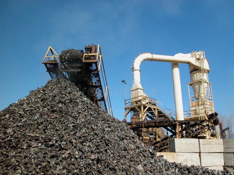 Shredded cars being processed for recycling. Claw machine stock images, royalty-free photos and pictures