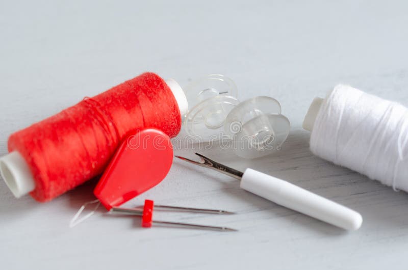 Red Accessories for Sewing on White Background. Needlework and Craft