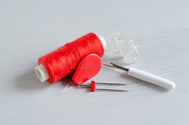 Red Accessories for Sewing on White Background. Needlework and Craft
